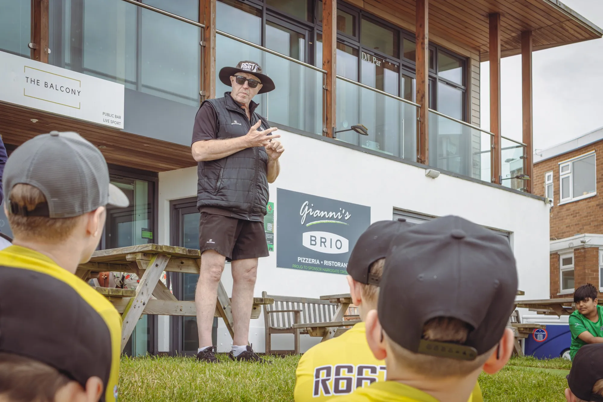 An R66T Academy coach talking to a group of young players
